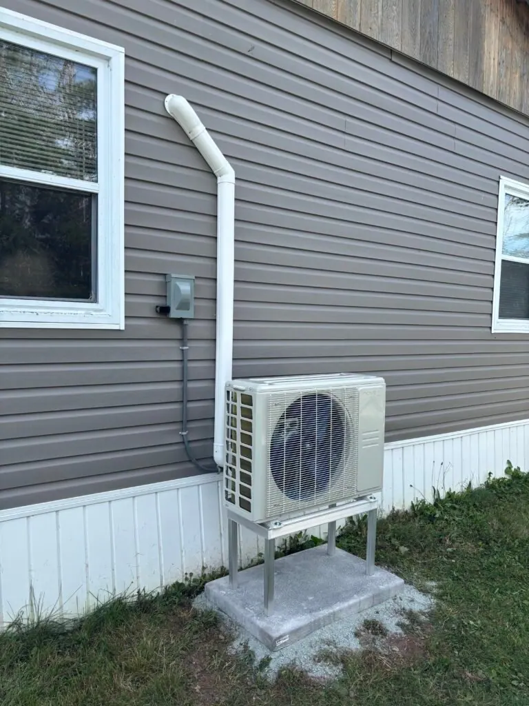 Single-zone ductless heat pump outdoor unit with tidy line-set cover and disconnect